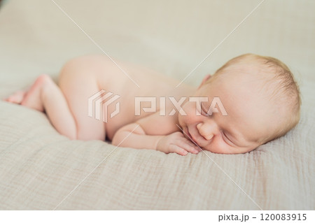 The baby is sleeping peacefully in his cozy nest. Newborn photo session captures the serene innocence and warmth of early moments 120083915