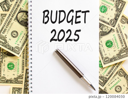 Planning budget 2025 new year symbol. Concept words Budget 2025 on beautiful white note. Beautiful background from dollar bills. Black pen. Business budget 2025 new year concept. Copy space. 120084030