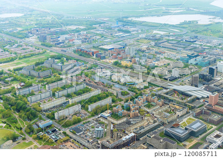 An aerial view of city Amsterdam, Netherlands, showing over rooftops of neighborhood cloudy weather 120085711