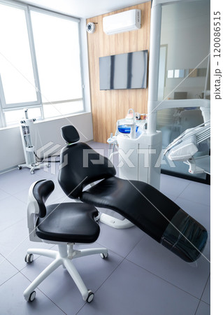 Empty stomatologist workplace consulting room with tools for teeth treatment Empty stomatologist workplace consulting room with tools for teeth treatment 120086515