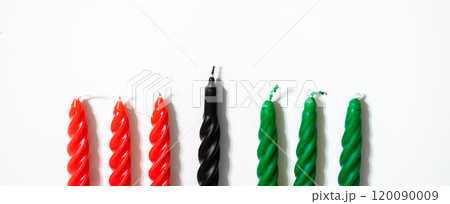 Happy Kwanzaa concept. Afro-American holiday. Seven candles - red, black and green. African heritage symbol on white background. 120090009