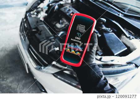 OBD scanner tools , OBD Scanner in use by mechanic over car engine background 120091277