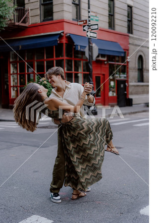 A Romantic Couple Dancing Together in a Vibrant Urban Setting Filled with Life and Energy A Romantic Couple Dancing Together in a Vibrant Urban Setting Filled with Life and Energy 120092210