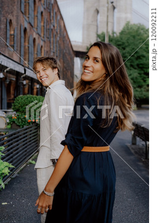 A Stylish Couple Enjoying a Leisurely Stroll Through the Urban Cityscape Setting 120092211