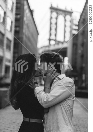 A couple passionately embracing each other in the vibrant urban landscape of the city A couple passionately embracing each other in the vibrant urban landscape of the city 120092222