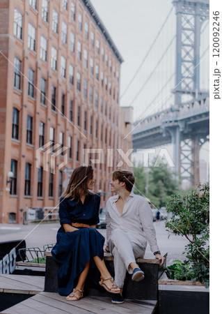 A Romantic Couple Posing Together Against the Iconic Bridge Backdrop in the Evening Light 120092246