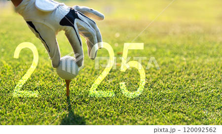 Close up hand Golfer woman putting golf ball for Happy New Year 2025 on the green golf for new healthy. Close up hand Golfer woman putting golf ball for Happy New Year 2025 on the green golf for new healthy. 120092562