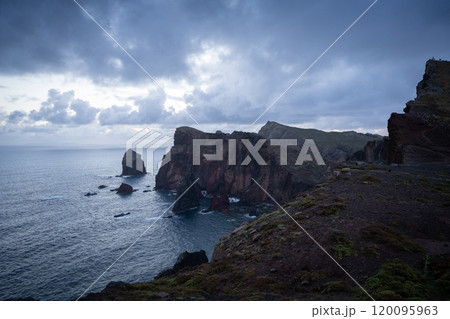 Rough islandic landscape with high cliffs and storm clouds above shot on dawn, Madeira, Portugal 120095963