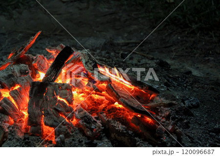 Close-up of a campfire at night. Ashes. Blazing branches Close-up of a campfire at night. Ashes. Blazing branches 120096687