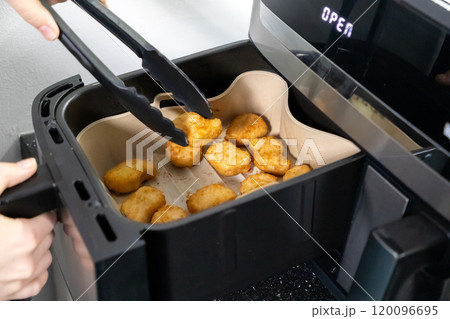Nuggets cooked in an air fryer. Cooking in an air fryer. Nuggets cooked in an air fryer. Cooking in an air fryer. 120096695