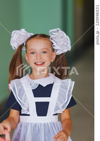 Happy cute little girl in school uniform in school corridor Happy cute little girl in school uniform in school corridor 120096831