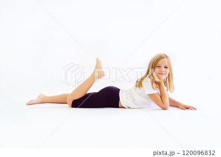 Cheerful teenage girl in white t-shirt and black breeches on white background Cheerful teenage girl in white t-shirt and black breeches on white background 120096832