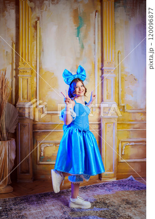 Cute teenage girl in blue doll dress with big blue bow posing. Cute teenage girl in blue doll dress with big blue bow posing. 120096877