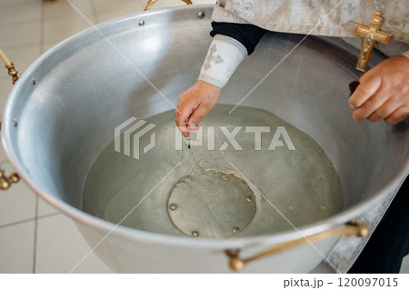 The priest performs chrismation at the sacrament of baptism. 120097015