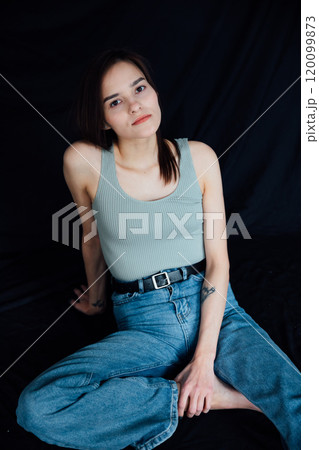 Portrait of Beautiful Fashionable Slender Woman in Jeans on Black Background Portrait of Beautiful Fashionable Slender Woman in Jeans on Black Background 120099873