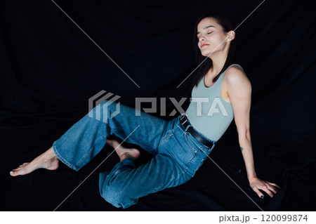 Portrait of Beautiful Fashionable Slender Woman in Jeans on Black Background Portrait of Beautiful Fashionable Slender Woman in Jeans on Black Background 120099874