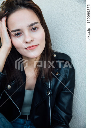 Portrait of a beautiful fashionable slender woman in a black leather jacket 120099876