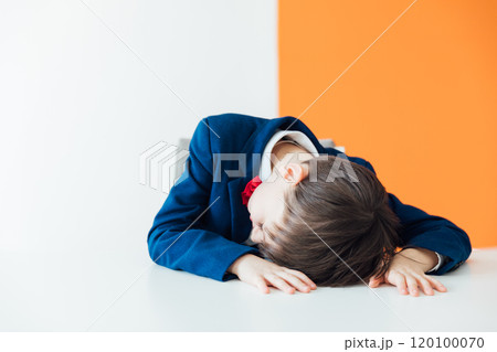 Schoolboy Boy In Business Suit Sleeping Tired At Table Schoolboy Boy In Business Suit Sleeping Tired At Table 120100070