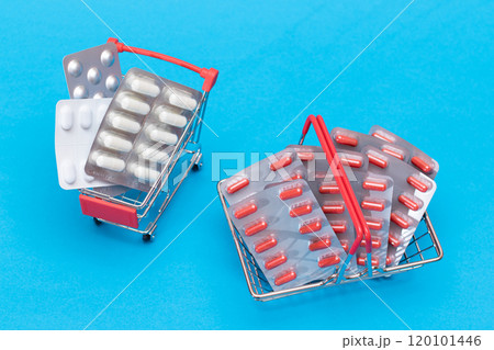 Pills and Capsules in Shopping Cart on Blue Background 120101446