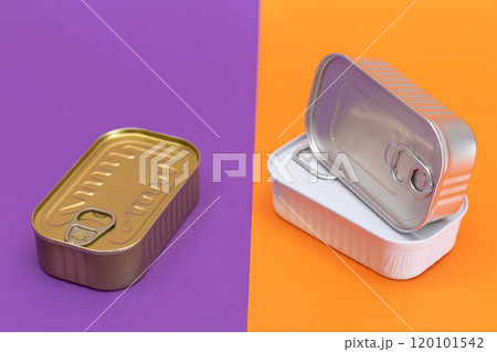 A Group of Stacked Tin Cans with Blank Edges on Split Orange and Violet Background A Group of Stacked Tin Cans with Blank Edges on Split Orange and Violet Background 120101542