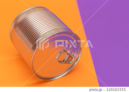 Unopened Tin Can on Split Orange and Violet Background 120101555