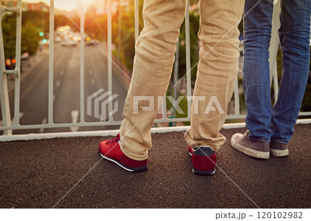 Together were on top of the world. Rearview shot of a couple standing together on a city bridge. Together were on top of the world. Rearview shot of a couple standing together on a city bridge. 120102982