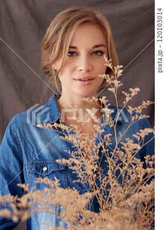 You can plant a dream. Shot of a beautiful young woman holding a dried out plant. You can plant a dream. Shot of a beautiful young woman holding a dried out plant. 120103014