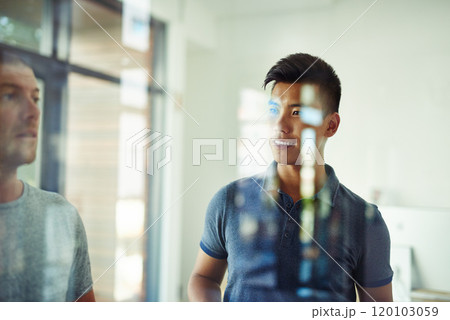 Planning is the first step. Cropped shot of a group of young designers planning on a glass board. Planning is the first step. Cropped shot of a group of young designers planning on a glass board. 120103059
