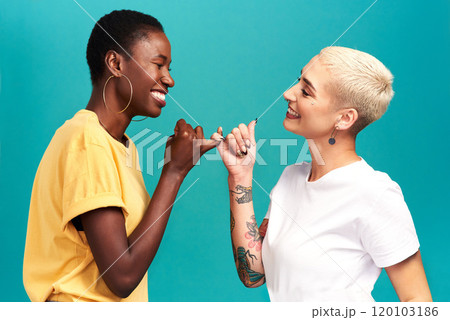 You can count on me. Studio shot of two young women linking their fingers against a turquoise background. 120103186