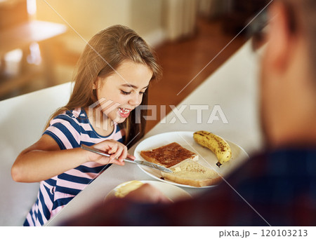 She can butter her own bread. Cropped shot of an adorable little girl having breakfast with her father in the kitchen. 120103213