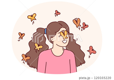 Little girl among butterflies flying and landing on face for spring mood concept 120103220