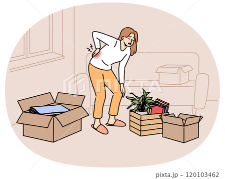 Sick woman moving to new apartment and suffers from back pain, stands among heavy boxes 120103462