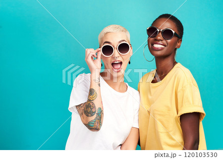 The future sure is looking bright. Studio shot of two young women wearing sunglasses against a turquoise background. 120103530