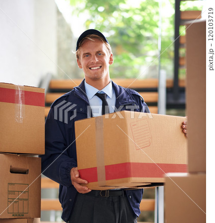Delivering direct to your door. Shot of a happy courier holding a box. Delivering direct to your door. Shot of a happy courier holding a box. 120103719