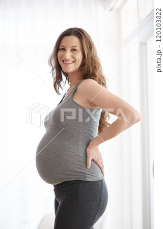 Ive never been healthier or happier. Cropped portrait of a young pregnant woman standing in her home. 120103822
