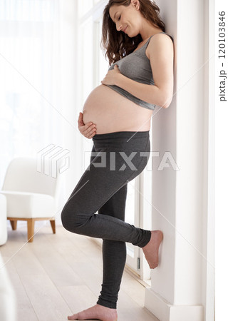 Shes expecting. Full length shot of a young pregnant woman standing in her home. 120103846