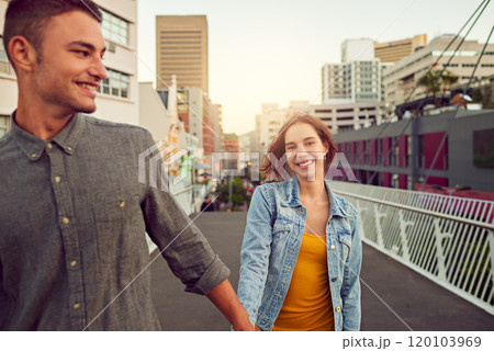 Romantic strolls in the city. Shot of a happy young couple enjoying a romantic walk together in the city. Romantic strolls in the city. Shot of a happy young couple enjoying a romantic walk together in the city. 120103969