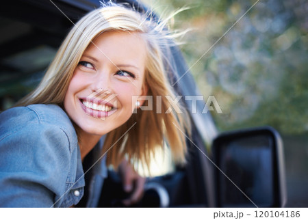 Feeling carefree outdoors. A young woman feeling the breeze in her hair through an open car window. Feeling carefree outdoors. A young woman feeling the breeze in her hair through an open car window. 120104186