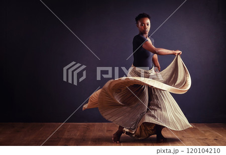 Feel the motion. Female contemporary dancer in a dramatic pose against dark background. Feel the motion. Female contemporary dancer in a dramatic pose against dark background. 120104210