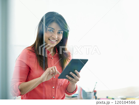 Creating a social media account for her business. Cropped shot of a young creative professional using a digital tablet. Creating a social media account for her business. Cropped shot of a young creative professional using a digital tablet. 120104566