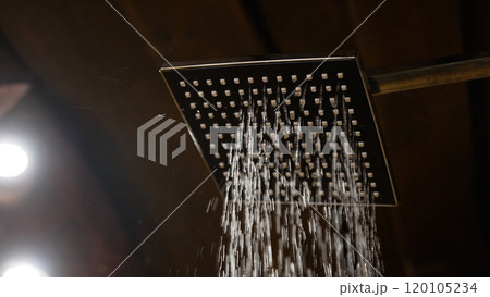 Close-up interior of a stylish shower spraying water. A stylish shower from which water begins to pour, slow motion. 120105234