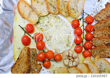 French cuisine. Baked Camembert cheese with garlic, thyme and toasted bread. French cuisine. Baked Camembert cheese with garlic, thyme and toasted bread. 120105467