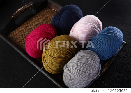 Multicolored wool yarn on tray. Balls of yarn in different colors. Wool yarn for hand knitting. Concept of hobby. 120105682