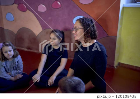 5-7 year old children sit in a circle at an acting class, extracurricular activities 5-7 year old children sit in a circle at an acting class, extracurricular activities 120108438
