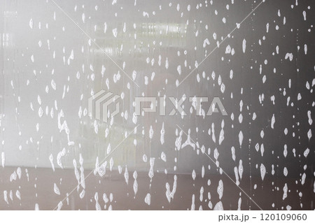 car cleaning and washing with foam soap on the gray car background 120109060