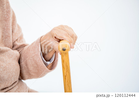 Aged hand with cane 120112444
