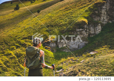 Woman Traveler Hiking Alone in Summer Mountains 120113695