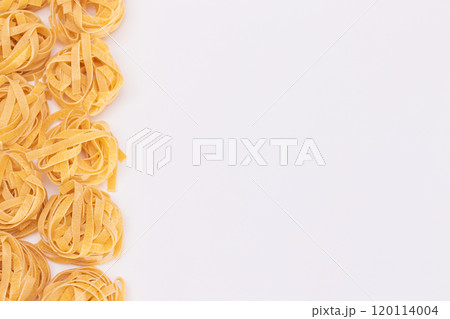 Classic Italian Raw Egg Fettuccine on White Background Classic Italian Raw Egg Fettuccine on White Background 120114004