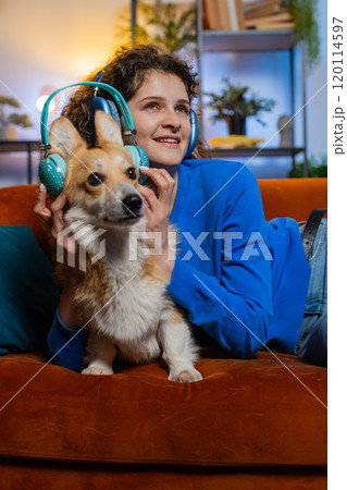 Joyful relaxed woman listening to smartphone music through wireless headphones lying on sofa dancing Joyful relaxed woman listening to smartphone music through wireless headphones lying on sofa dancing 120114597