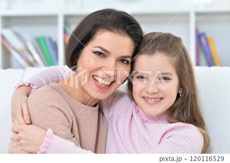 Little girl with her mother posing at home 120116529